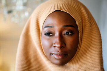Tranquil portrait of beautiful young black muslim woman wearing hijab