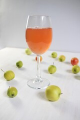 Glass of fresh apple juice on white background