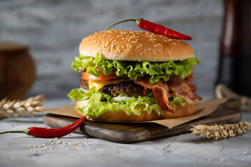 Homemade burger with chili on a wooden table