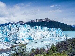View of the Perito Moreno glacier with details of the iceberg and ice on a sunny day with clouds