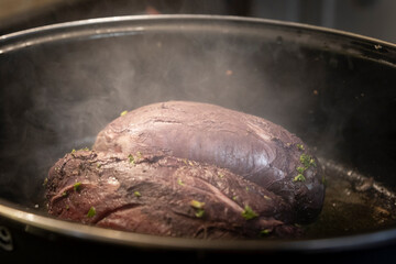 Two pieces of beef roast in a casserole dish