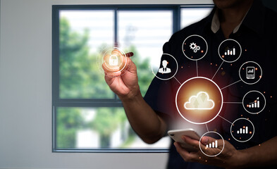 A man in a suit uses his left hand to hold the cloud computing symbol in his hand and the business symbol is placed around it.