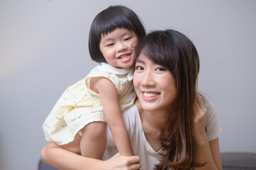Portrait of happy asian mom and daughter