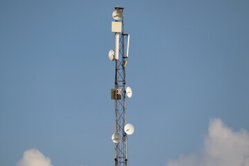 Fototapeta na wymiar Mathura, Uttar Pradesh India- August 25 2021: A tall mobile towers with clear background sky. Telecom service provider for the advanced 5g internet connection.