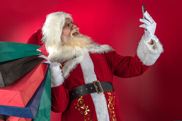 Emotional senior male model old man with a natural white beard in the role of Father Christmas