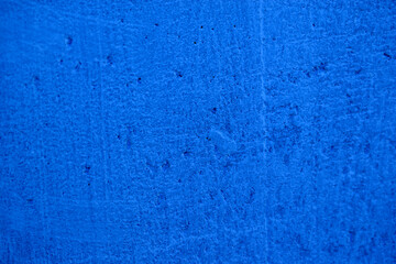 Fototapeta na wymiar Blue background of a rough painted wall