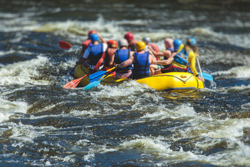 Raft boat during whitewater rafting extreme water sports on water rapids, kayaking and canoeing on the river, water sports team with a big splash of water