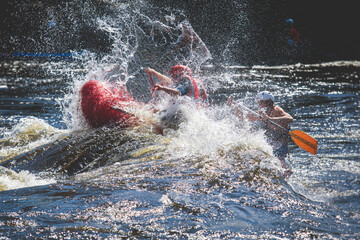Raft boat during whitewater rafting extreme water sports on water rapids, kayaking and canoeing on the river, water sports team with a big splash of water © tsuguliev