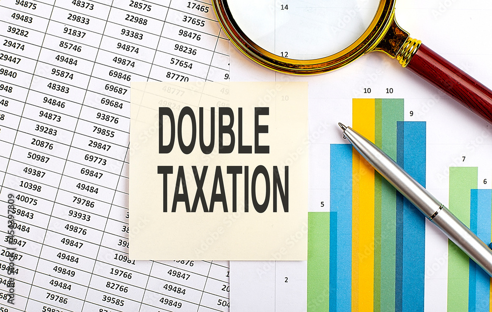 Poster business concept. top view of stiscker with text double taxation on chart background