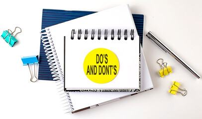 Sticker with DO'S AND DONT'S text on notebooks on the white background