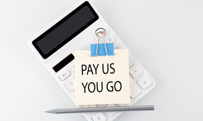 PAY AS YOU GO text on the sticker on white calculator