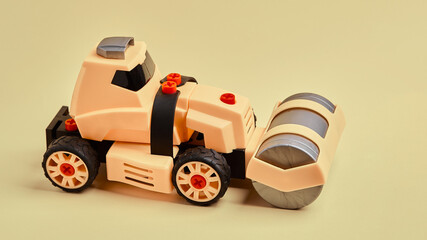 Children's toy plastic yellow roller skating machine on a yellow background. Photo for a toy store...