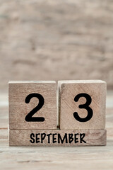 cube calendar for september on wooden background with copy space