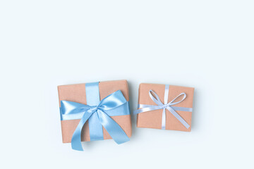 Gift boxes on a blue pastel background. Present tied with ribbon. Congratulation concept with copyspace.