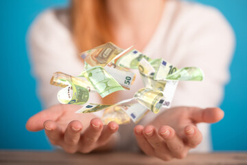 euro bills flying around  in hand