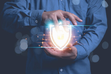 Businessman holding shield protection internet network security from cyber attacks. Protect system...