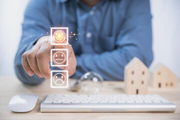 A businessman pressing smiley face emoticon on the virtual touch screen. Take on loans money from...