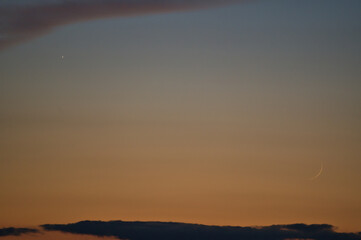 Beautiful evening view of crescent Moon and Venus seen from Ticknock Forest National Park, County Dublin, Ireland. Telephoto shot. Golden hour gradients