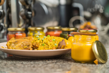 Rice dish with chicken and huacayna sauce served with jars of sauce