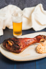 Vertical photo of a dish of turkey served with salad next to a glass of beer