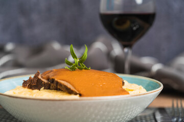 Selective focus on a dish with cornstarch with roasted beef covered with sauce