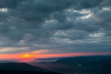 bright sunrise in the mountains with blue sky