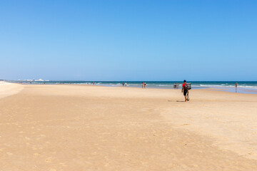 Artisanal fisherman walking on the beach, Cacela Velha, Algarve