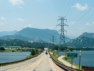 Road leading to the mountains with water on either side.
