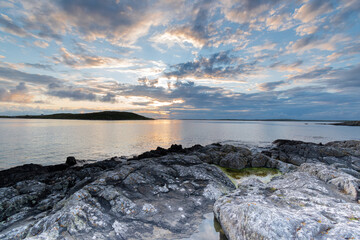 sunset over the ocean horizon on a warm summers evening near sky road in Connemara.