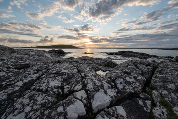 sunset over the ocean horizon on a warm summers evening near sky road in Connemara.