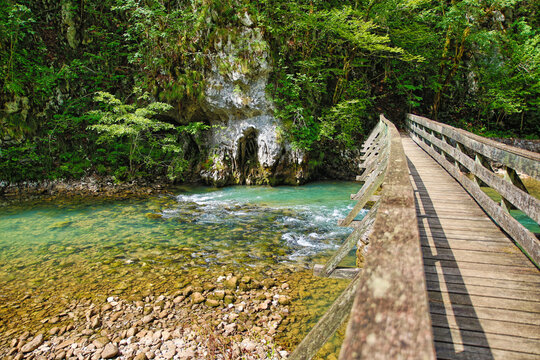 a wooden bridge over the river kupa in risnjak national park