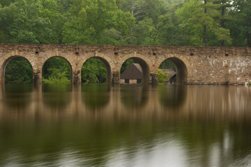Fototapeta na wymiar Brick bridge over the river