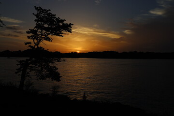 Fototapeta na wymiar Sunset over the lake. Twilight over the river. Beautiful sunset sky.
