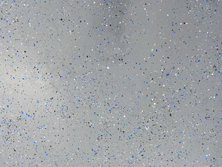 A freshly painted with a gray epoxy finish sprinkled with blue, black and white plastic chips.