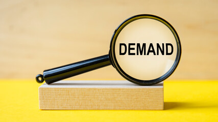 admission word demand magnifying glass on wooden background