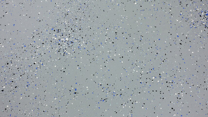 A freshly painted with a gray epoxy finish sprinkled with blue, black and white plastic chips.