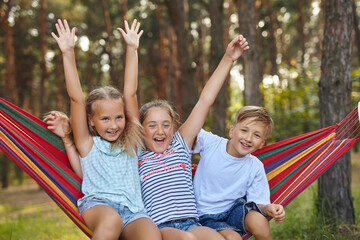 Fun in the garden kids playing in colorful hammock