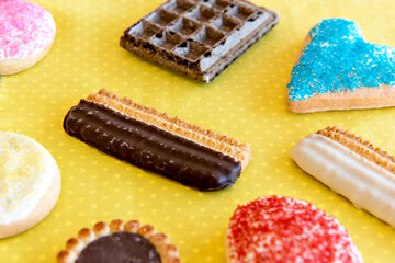 wafer, biscuits and cookies on yellow background.