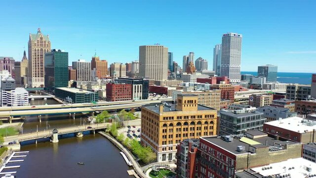 Very good aerial establishing shot of downtown Milwaukee Wisconsin business district, Milwaukee River and skyscrapers.