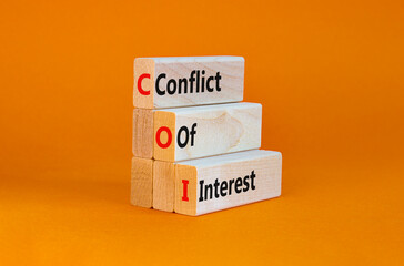 COI, Conflict of interest symbol. Wooden blocks with concept words 'COI, conflict of interest'. Beautiful orange background. Copy space. Business and COI, conflict of interest concept.