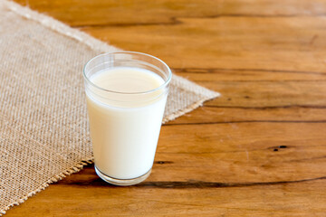 glass of milk on wooden table.