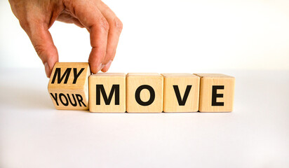 My or your move symbol. Businessman turns a wooden cube and changes words 'your move' to 'my move'. Beautiful white table, white background. My or your move and business concept. Copy space.