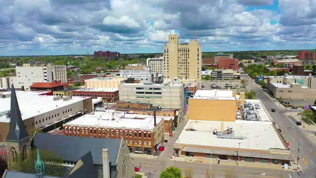 Good drone aerial of downtown Flint, Michigan with old buildings and empty lots, suggesting economic downturn.