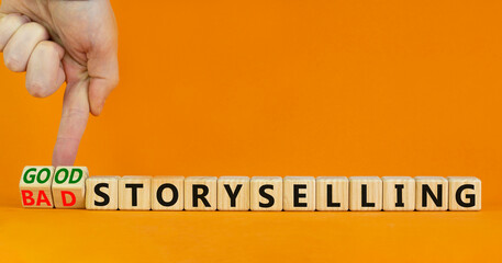 Good or bad storyselling symbol. Businessman turns wooden cubes, changes words 'bad storyselling' to 'good storyselling'. Beautiful orange background, copy space. Business and storytelling concept.