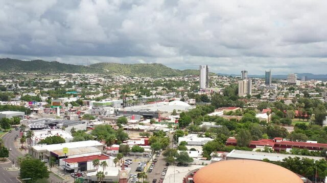 Aerial panoramic view of Hermosillo, Sonora in M&eacute;xico. Drone flying backwards with a blue and cloudy sky as background.