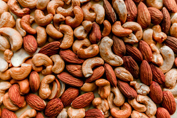 An abunAn abundance of cashews and almonds. Nut background. Proper nutrition.dance of cashews and almonds. Nut background. High quality photo