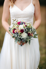Bride holding beautiful wedding bouquet in her hands close-up	