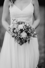 Bride holding beautiful wedding bouquet in her hands close-up
