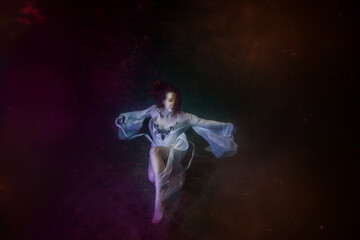 Fototapeta na wymiar Abstract underwater painting of a girl dressed in a white dress underwater.
