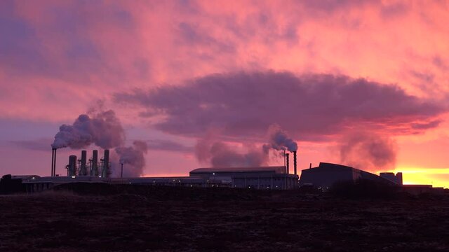 Establishing shot at sunset of a geothermal power plant producing clean energy in iceland.